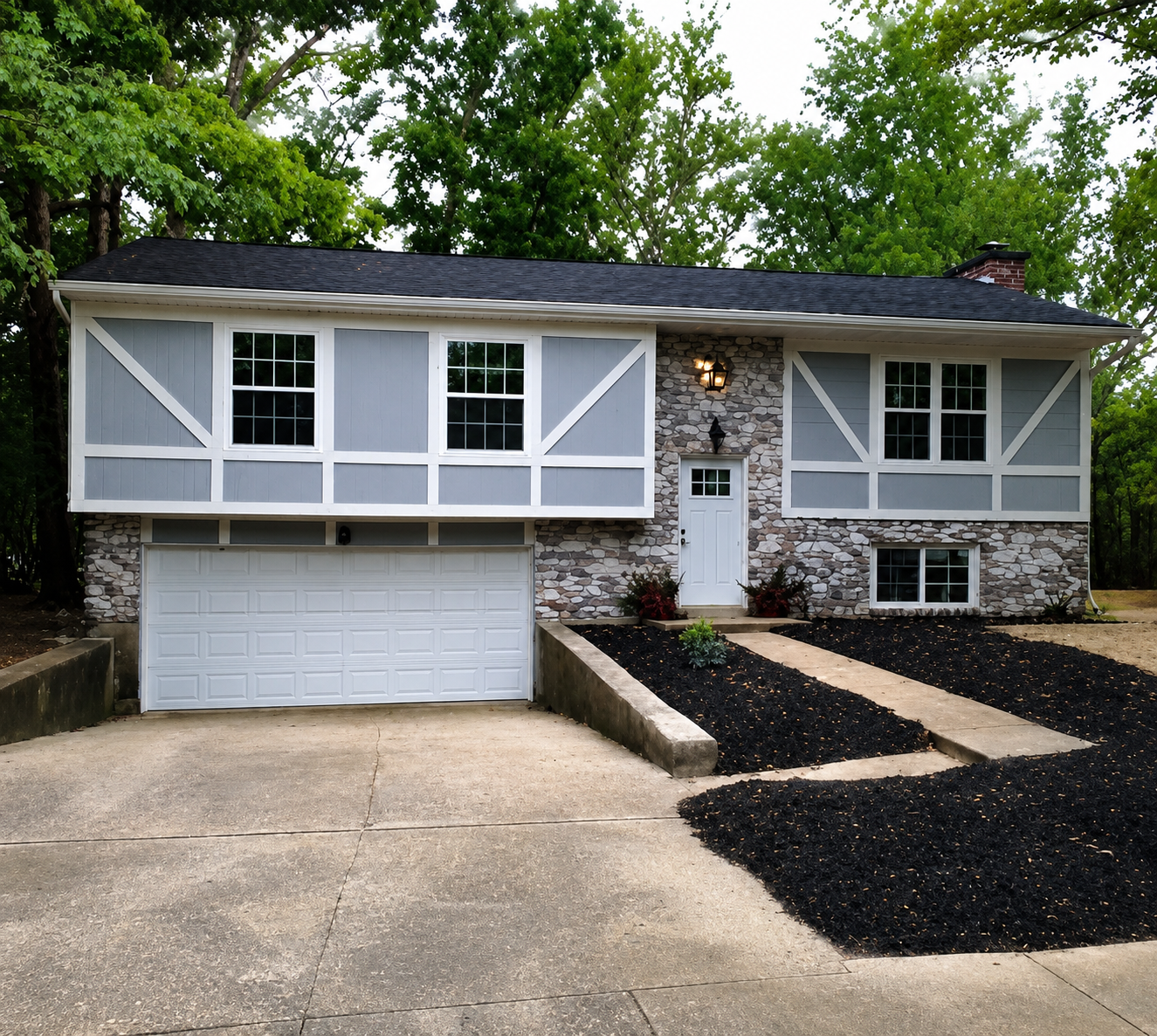 Suburban split-level house with garage and driveway.