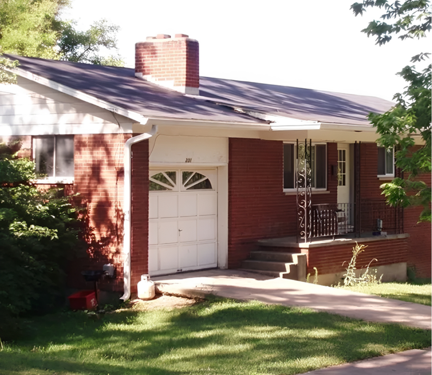 Red brick house with garage and porch.
