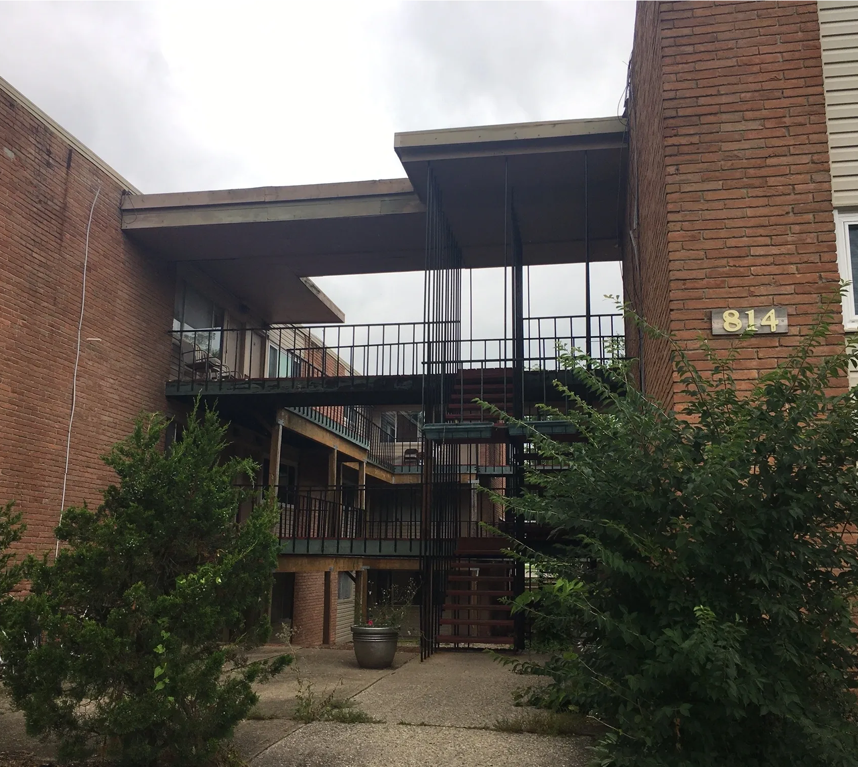 Brick building with outdoor metal staircase.