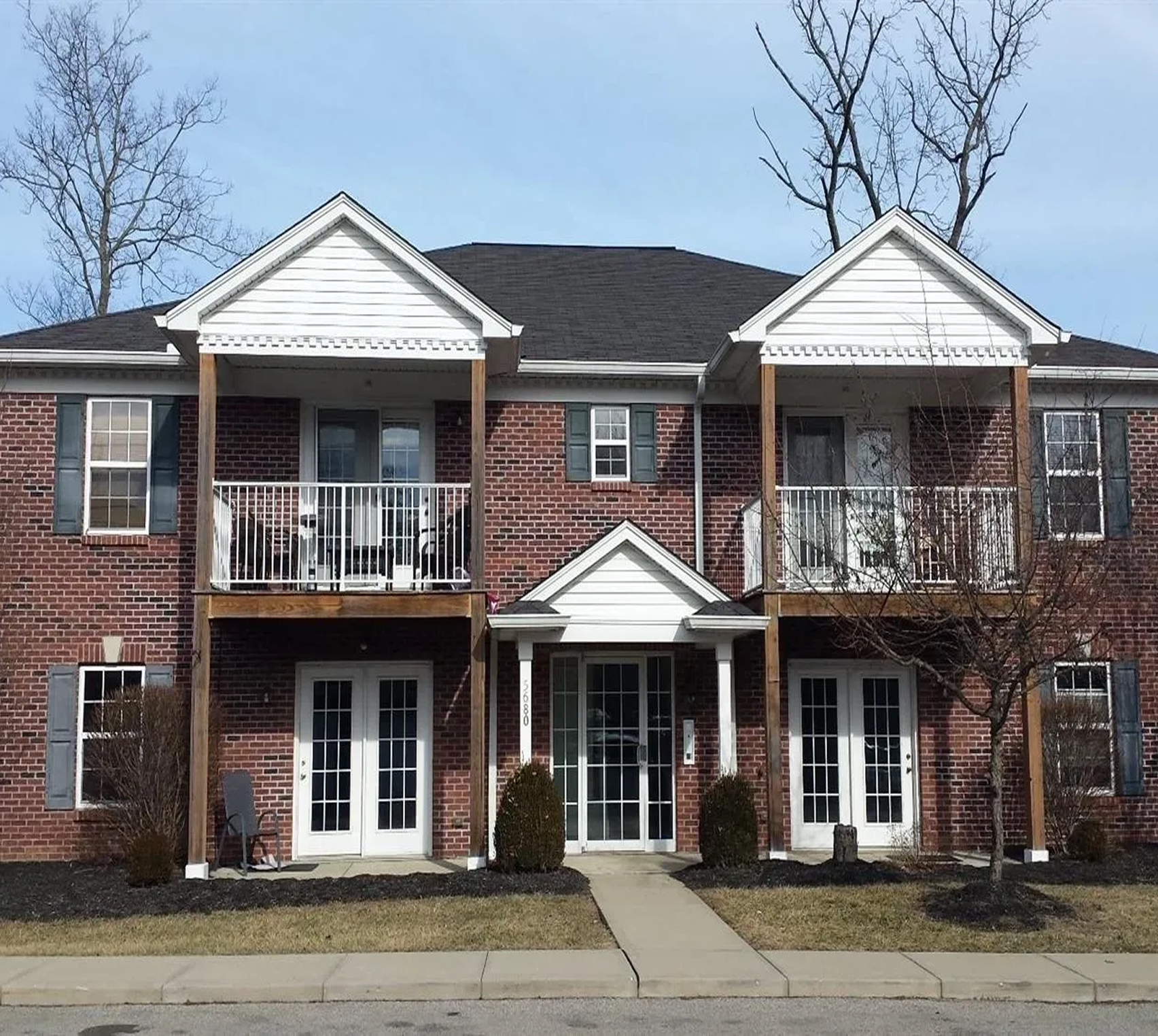 Two-story brick apartment building with balconies.