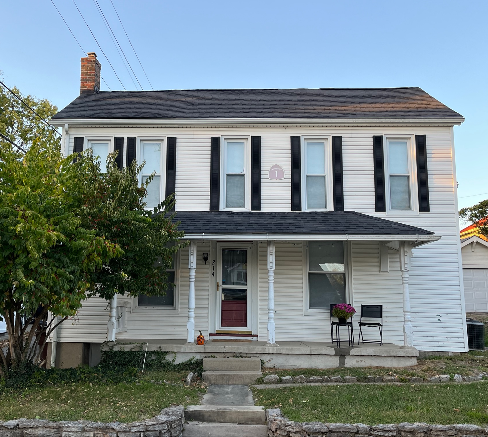 Two-story white house with front porch.