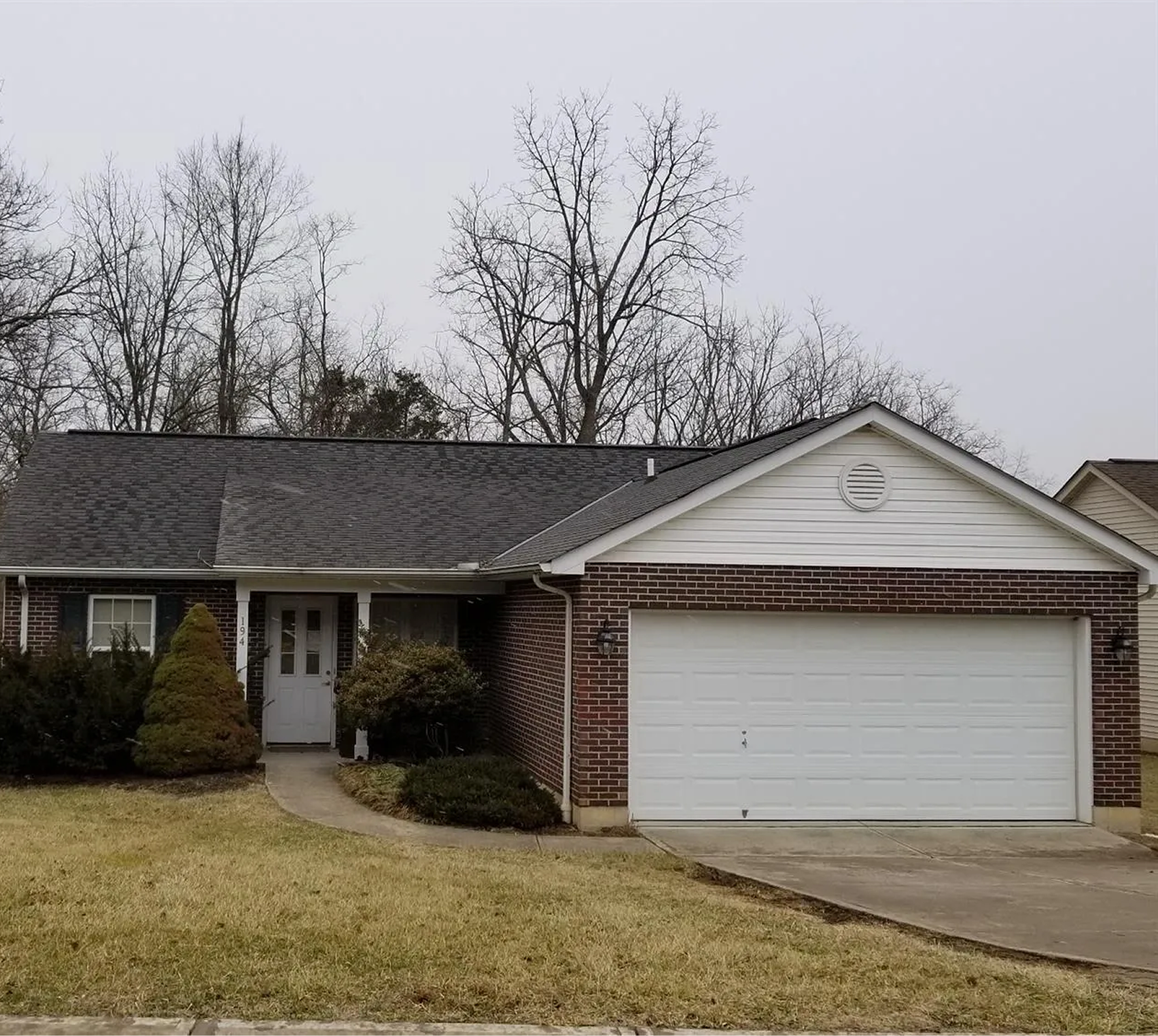Single-story brick house with attached garage.