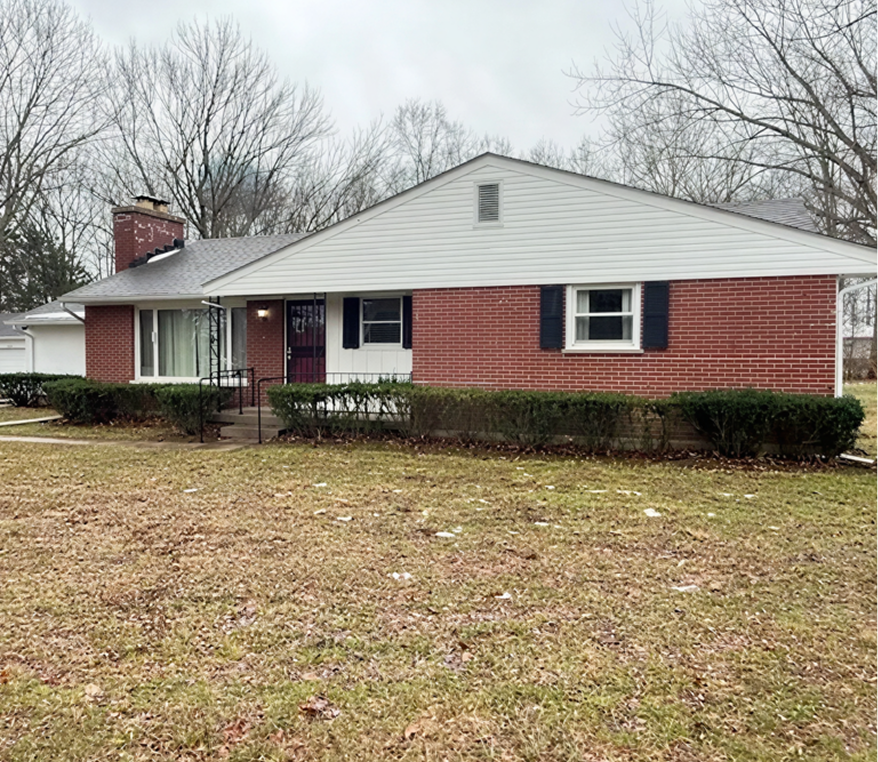 Single-story brick house with front yard.
