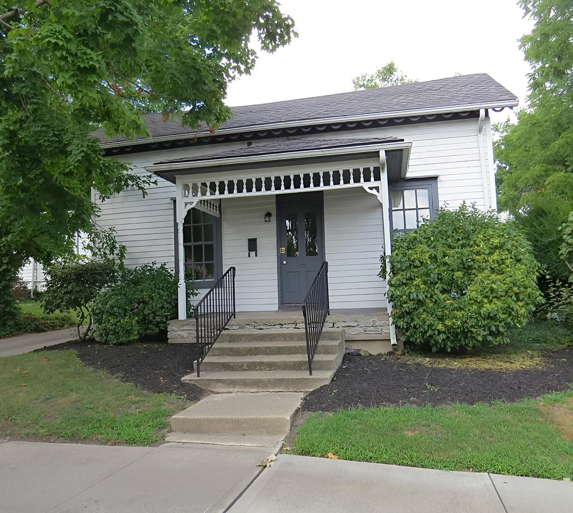 Small white house with front porch steps.