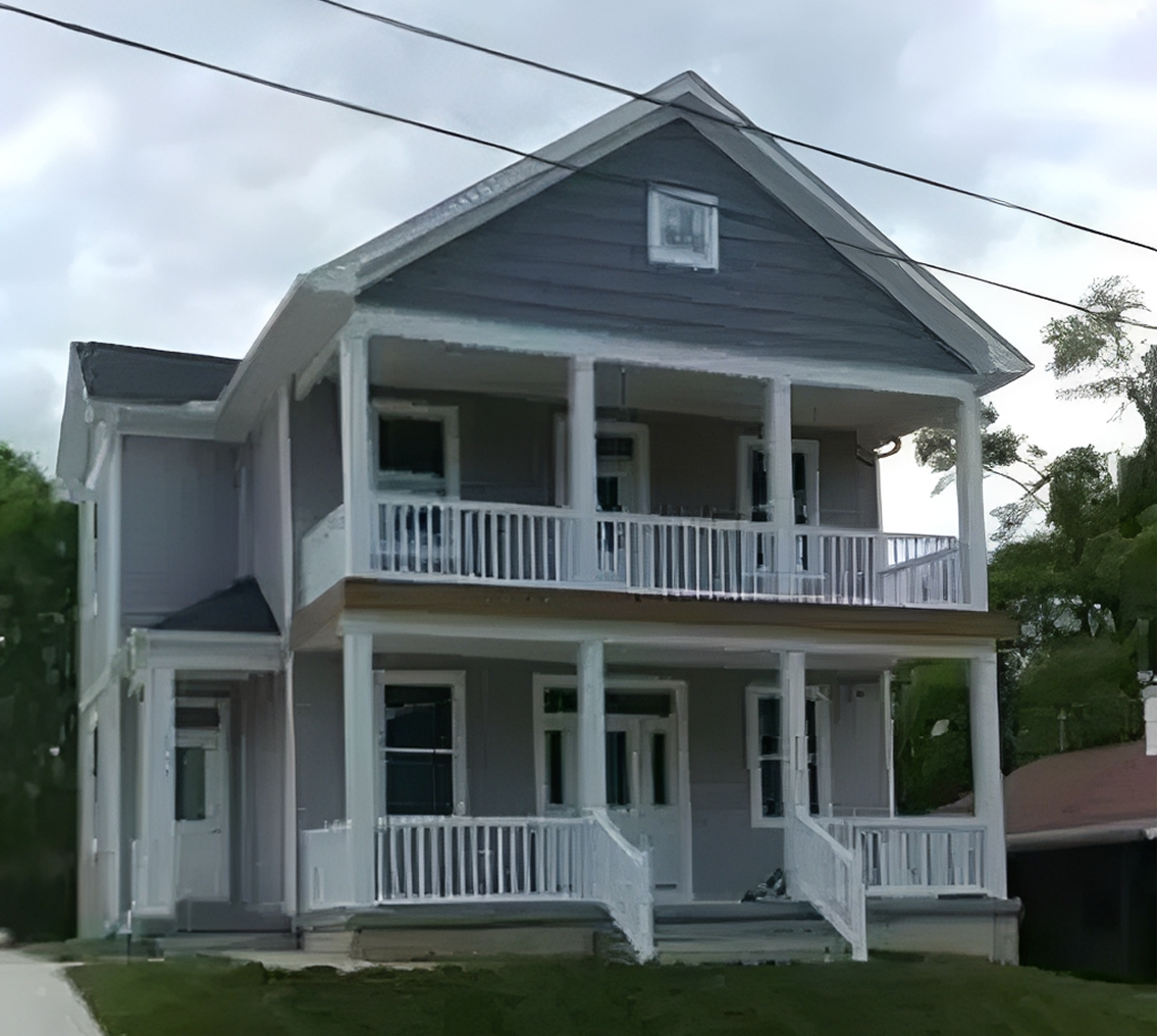 Two-story house with white railings.
