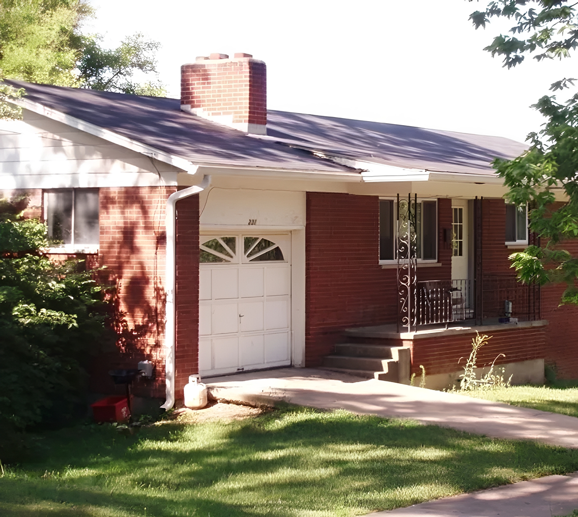 Red brick house with attached garage.