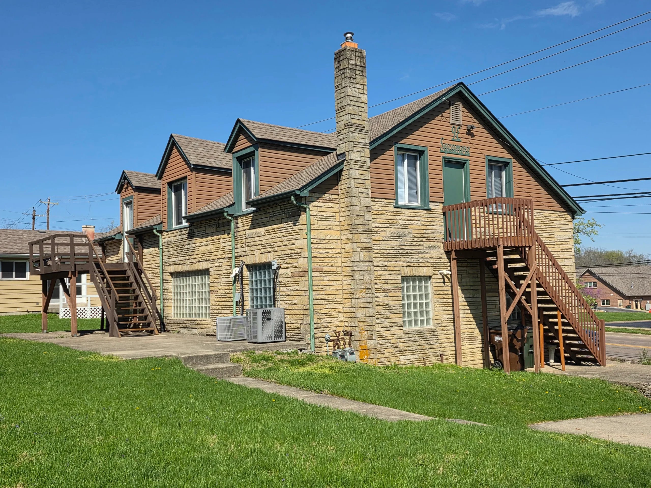 Stone house with dormers and exterior stairs