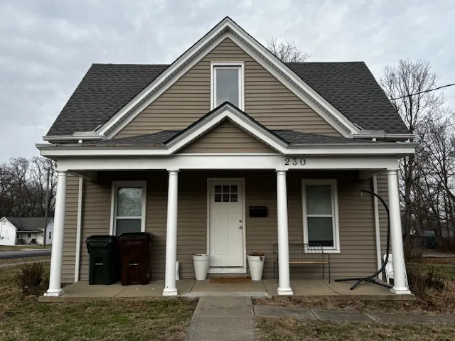 Brown house with white trim and porch