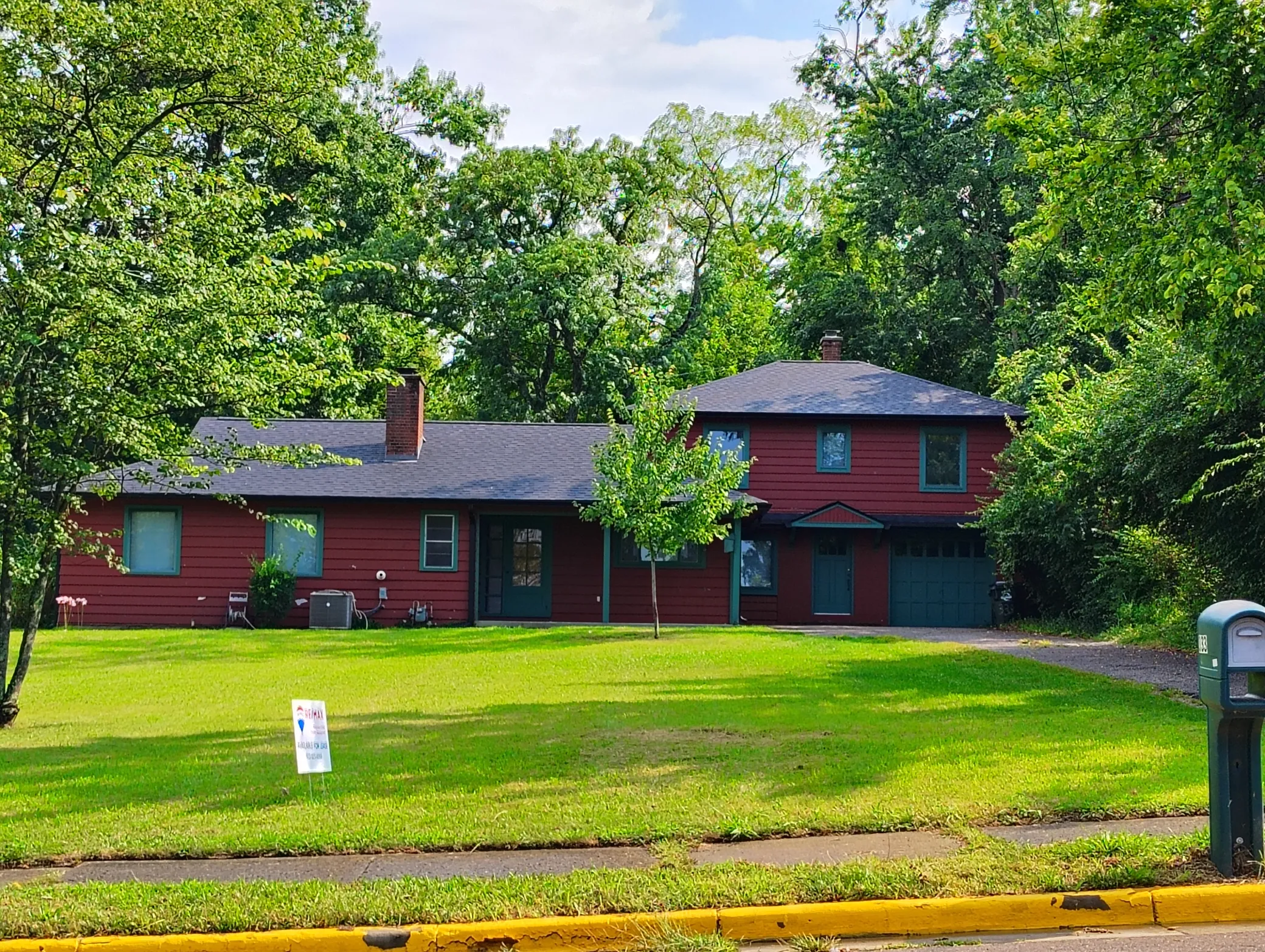 House for sale with "For Rent" sign