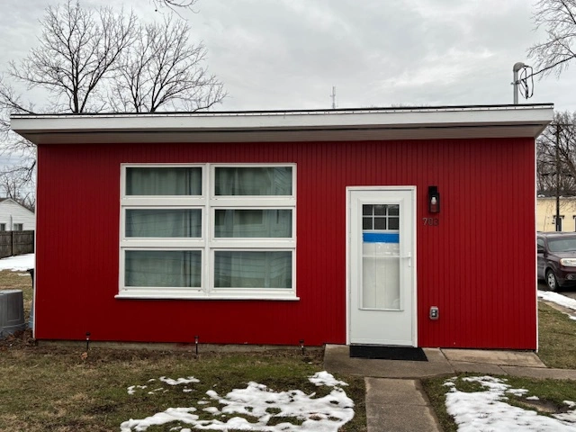 Small red house with white door